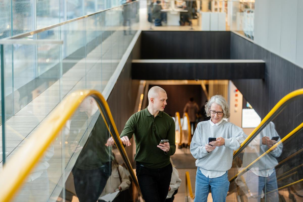 A man and a woman on an escalator