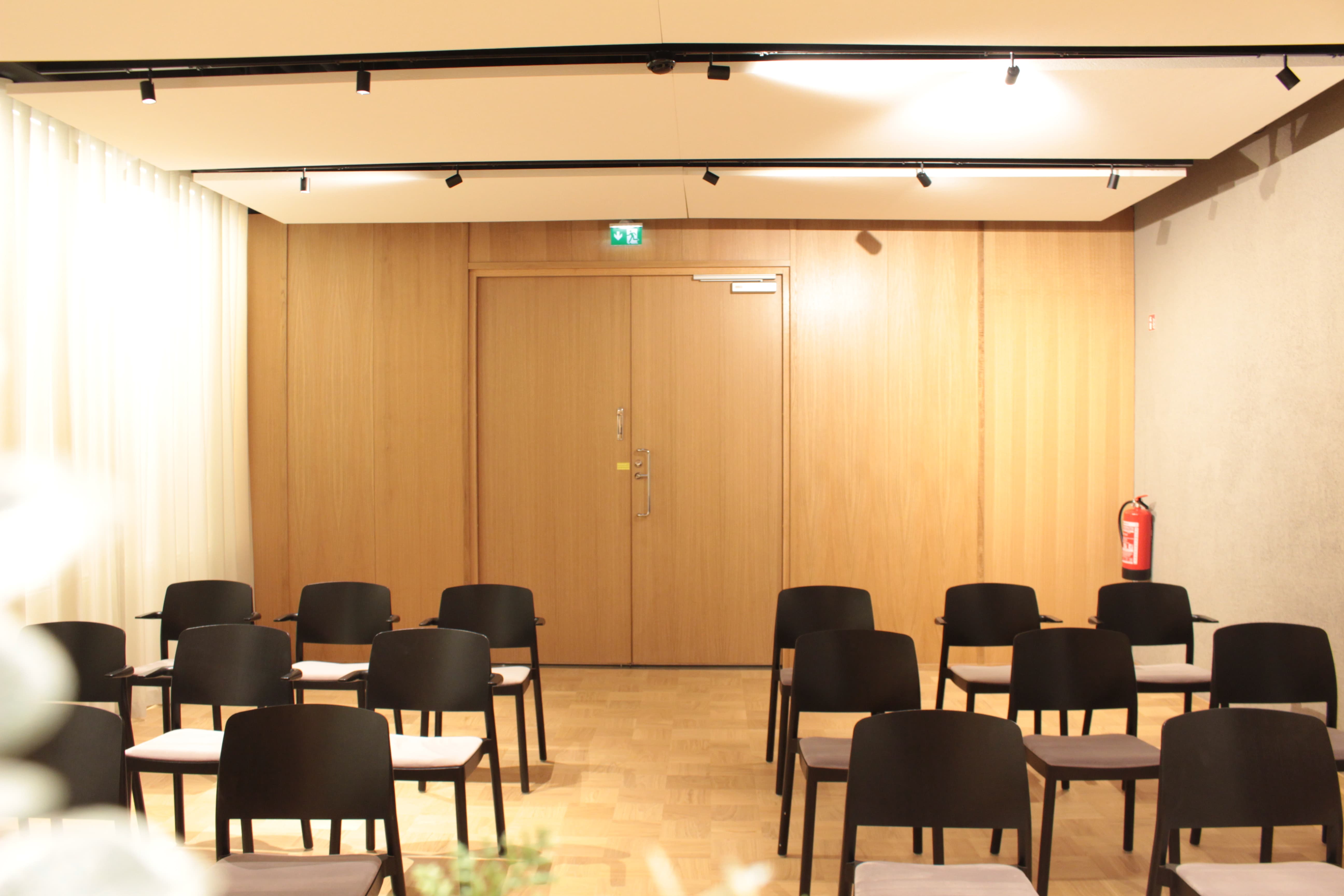 A warmly lit room with chairs.